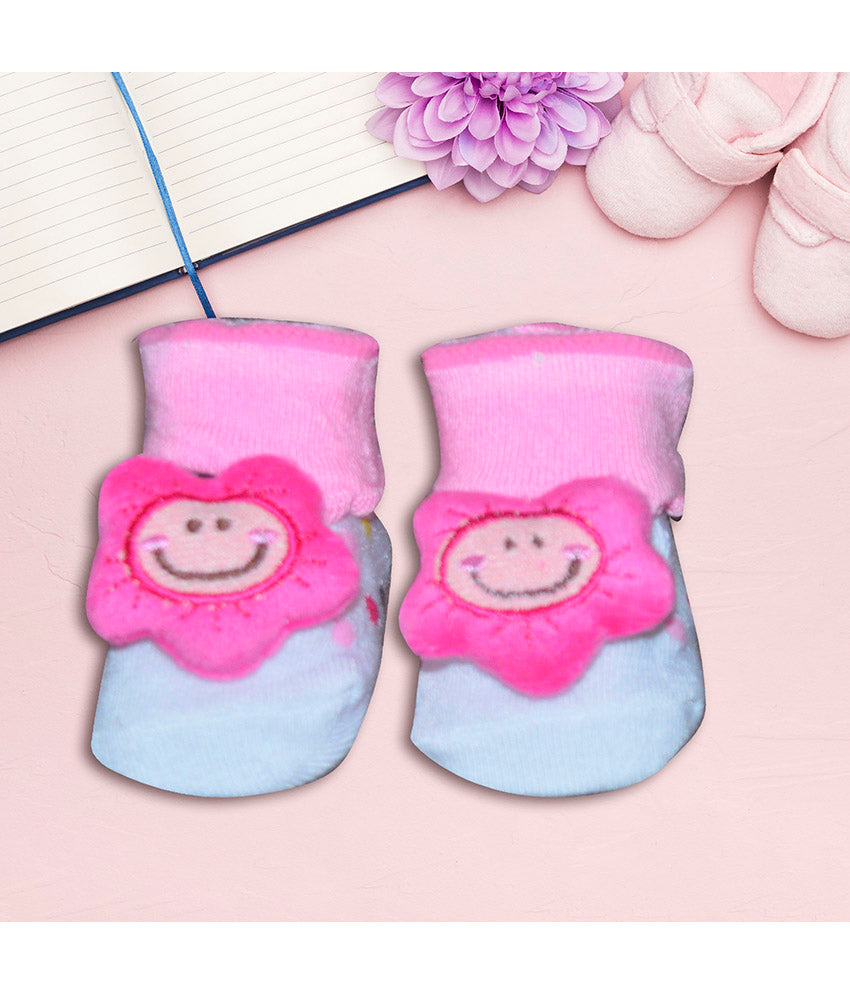 Pair of pink baby socks with flower design