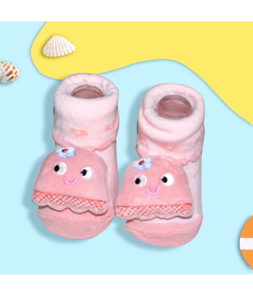 Pair of pink baby socks with smiling faces 